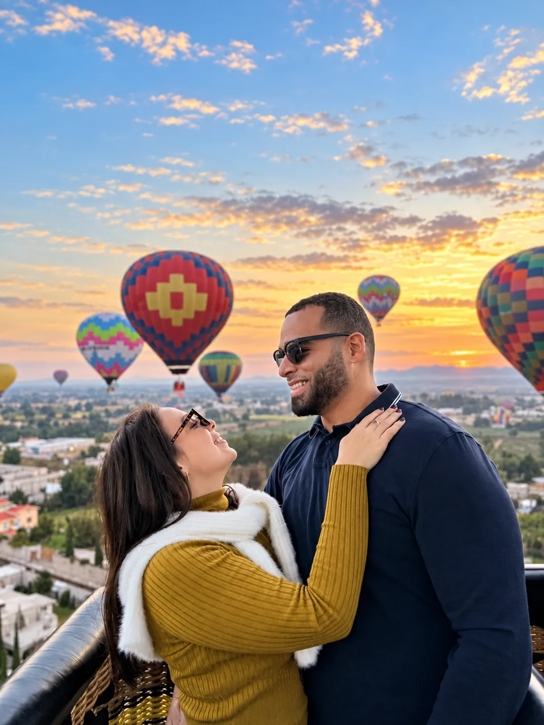 Couple in front of the balloons at sunrise