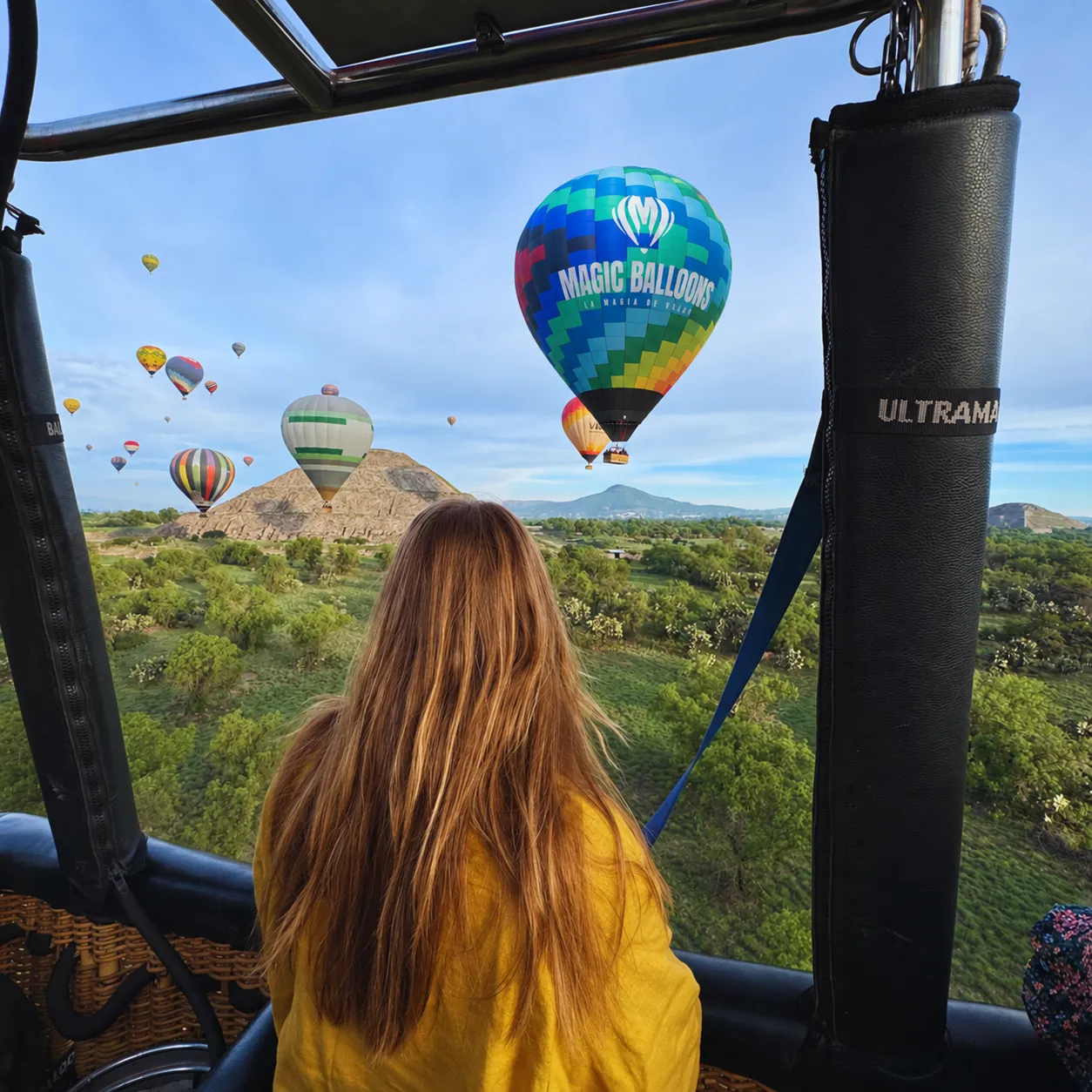 Passenger looking out at the pyramids from the balloon